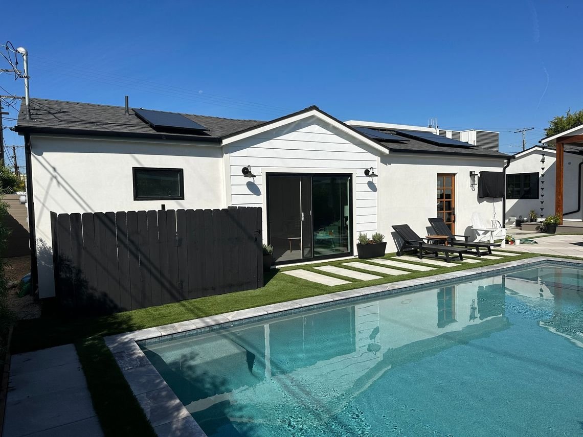 Detached studio ADU with French doors to a pool patio